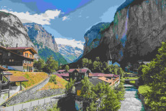An illustrative photo of houses near a valley with trees.