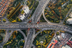 An illustrative photo of roads surrounded with trees.