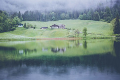 An illustrative photo of a house near a pond.