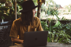 An illustrative photo of a man sitting at a table.