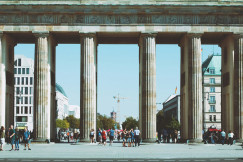 An illustrative photo of people under brown building.