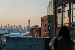 An illustrative photo of a woman taking photo of buildings.