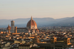 An illustrative photo of a view of a city with a domed building.