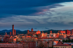 An illustrative photo of orange buildings in a city during sunset.
