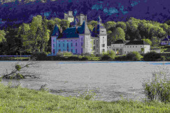 An illustrative photo of a large castle sitting on top of a lush green hillside.