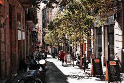 An illustrative photo of a person walking on an empty narrow street.