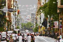 An illustrative photo of people walking on a street with traffic.