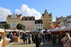 An illustrative photo of a crowd of people walking around a market.