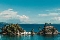 An illustrative photo of a small island in the middle of a body of water.