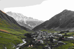 An illustrative photo of houses beside rocky mountains during daytime.