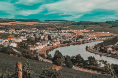 An illustrative photo of a town on a hill near a river.