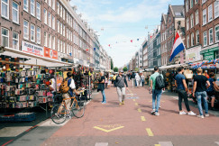 An illustrative photo of people walking on pedestrian lane on a street fair.