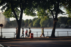 An illustrative photo of a group of people walking down a sidewalk.