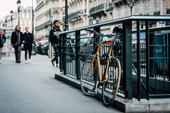 An illustrative photo of a parked orange bicycle.