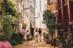 An illustrative photo of a group of people walking down a street.