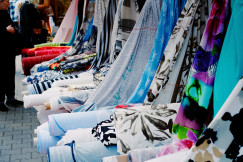 A row of colorful scarves on display on a sidewalk photo – Free Woman Image on Unsplash
