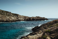 An illustrative photo of a formation of rocks in a sea.