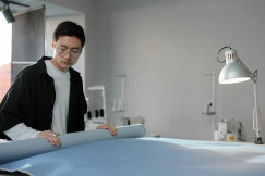 Person Holding a Blue Rolled Fabric · Free Stock Photo