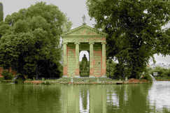 An illustrative photo of a gazebo in the middle of a lake surrounded by trees.