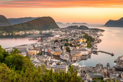 An illustrative photo of houses on an island in a body of water.