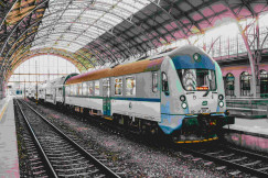 An illustrative photo of a passenger train pulling into a train station.