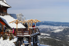 An illustrative photo of a group of people in a café in the snow-covered mountains.