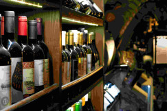 An illustrative photo of bottles of wine on a shelf.