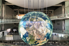 An illustrative photo of a giant globe inside of a building.
