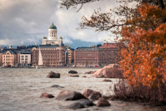 An illustrative photo of a body of water with a large building in the background.