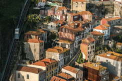 An illustrative photo of white houses on a hill.