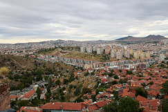 An illustrative photo of a view of a city from the top of a hill.