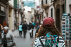 An illustrative photo of a woman walking down the street.