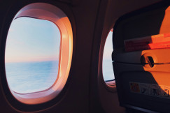 An illustrative photo of an airplane window during daytime.