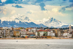 An illustrative photo of a view of a city with mountains.