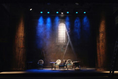 An illustrative photo of a brown wooden chair inside the a building.