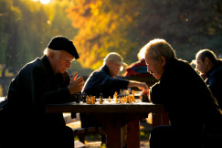 An illustrative photo of two man playing chess in shallow.