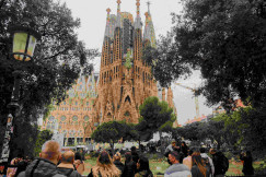 An illustrative photo of a crowd of people walking in front of a castle.