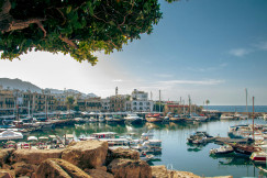 An illustrative photo of a harbor filled with lots of boats in a sea.