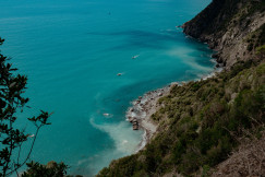 An illustrative photo of a body of water surrounded by a lush green hillside.