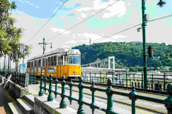 An illustrative photo of a yellow tram on a bridge.