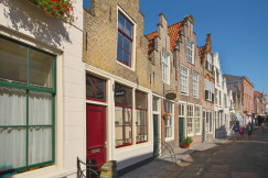 An illustrative photo of a row of buildings on a city street.