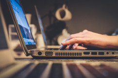 An illustrative photo of a person typing on a laptop.