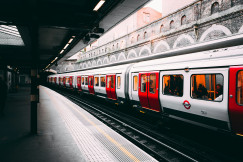 An illustrative photo of a white and red train on a station.