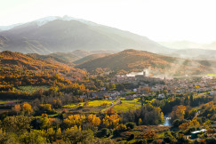 An illustrative photo of a town surrounded by mountains.