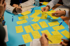 people writing on sticky notes