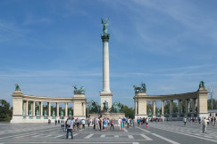 An illustrative photo of a group of people standing in front of a monument.