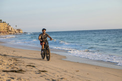 An illustrative photo of a man riding a bike.
