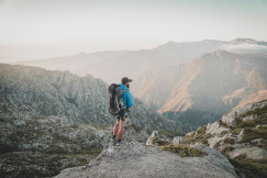 An illustrative photo of a group of a man walking on a rocky mountain.