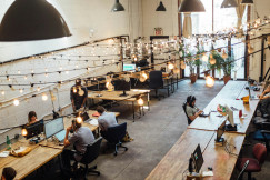 An illustrative photo of people sitting in front of computer monitors.