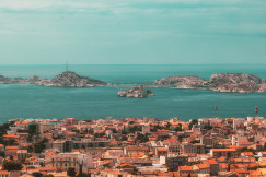An illustrative photo of city buildings near a sea.